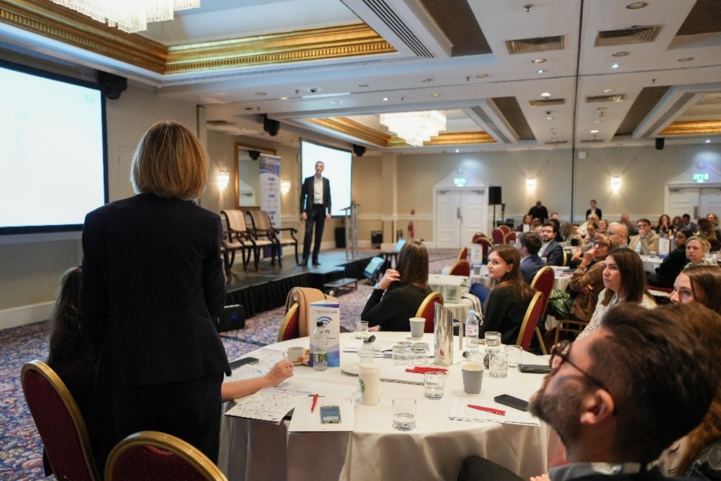 Attendees participate in a clinical research conference session focused on patient recruitment, engagement, and trial enrollment
